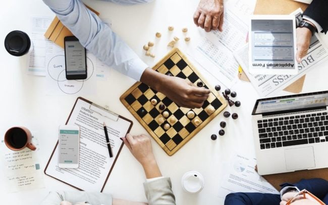 Employees sitting around the table designing a business strategy