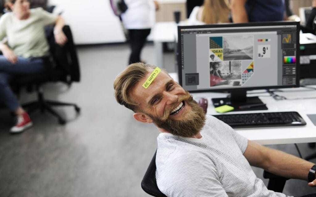 Happy employee by his desk